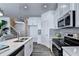 Modern kitchen with stainless steel appliances, subway tile backsplash, and white cabinets at 1569 Aiden Way # 35, Conyers, GA 30013