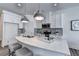 Bright kitchen features a white quartz island, modern pendant lights, and stainless steel appliances at 1569 Aiden Way # 35, Conyers, GA 30013