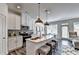 Modern kitchen with stainless steel appliances, kitchen island, and white cabinets at 1569 Aiden Way # 35, Conyers, GA 30013