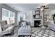 Bright living room features a comfortable chaise lounge, fireplace, and large window at 1569 Aiden Way # 35, Conyers, GA 30013