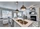 Open concept living space with kitchen island, fireplace, neutral decor, and wood-look floors at 1569 Aiden Way # 35, Conyers, GA 30013
