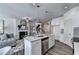 Open concept living space with fireplace, kitchen island with stainless steel appliances at 1569 Aiden Way # 35, Conyers, GA 30013