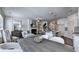 Open concept living space with dining table, fireplace, kitchen island, and neutral decor at 1569 Aiden Way # 35, Conyers, GA 30013