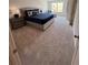 Spacious main bedroom featuring carpet, plush bedding, abundant light, and sitting area, with ample space at 1569 Aiden Way # 35, Conyers, GA 30013