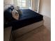 Close-up of the main bedroom with plush bedding and many pillows, providing a cozy and inviting setting at 1569 Aiden Way # 35, Conyers, GA 30013