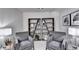 Comfortable sitting area with two gray chairs, bookshelves, and ambient lighting at 1569 Aiden Way # 35, Conyers, GA 30013