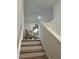 View of the stairway with light wood treads and white risers leading to an upper level, showcasing a decorative chair at 1569 Aiden Way # 35, Conyers, GA 30013
