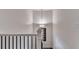 Stairway landing featuring modern railing, neutral walls, and contemporary light fixture at 1569 Aiden Way # 35, Conyers, GA 30013