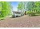 Backyard view of a house featuring a deck and lush trees at 1584 Allgood Ne Rd, Marietta, GA 30062