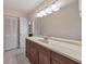 Bathroom with a large vanity, a full mirror, bright lighting and white bi-fold doors at 1584 Allgood Ne Rd, Marietta, GA 30062