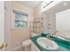 Bathroom featuring a white toilet, vanity, and metal shelving in a brightly lit space at 1584 Allgood Ne Rd, Marietta, GA 30062