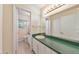 Bathroom featuring a green countertop, white cabinets and an adjoining view of the toilet at 1584 Allgood Ne Rd, Marietta, GA 30062