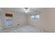 Neutral bedroom with a ceiling fan, carpet and access to the exterior through a glass paneled door at 1584 Allgood Ne Rd, Marietta, GA 30062