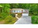 Charming single-story brick home featuring a well-manicured front yard, and a two-car attached garage at 1584 Allgood Ne Rd, Marietta, GA 30062