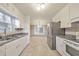 Functional kitchen featuring white cabinets, stainless steel appliances, and plenty of counter space at 1584 Allgood Ne Rd, Marietta, GA 30062