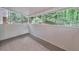 Enclosed sunroom with an exterior view of an outdoor fireplace and wooded backyard at 1584 Allgood Ne Rd, Marietta, GA 30062