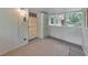 Enclosed sunroom with a gray wood floor, painted wainscotting, and a door to the outside at 1584 Allgood Ne Rd, Marietta, GA 30062