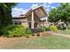 A welcoming clubhouse entrance with stone columns, manicured landscaping, and a brick facade at 3708 Ashford Creek Ne Hl # 3708, Atlanta, GA 30319