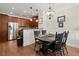 Cozy dining area adjacent to the kitchen featuring hardwood floors and modern lighting at 3708 Ashford Creek Ne Hl # 3708, Atlanta, GA 30319