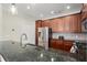 Well-equipped kitchen featuring granite countertops, stainless steel appliances, and dark wood cabinets at 3708 Ashford Creek Ne Hl # 3708, Atlanta, GA 30319
