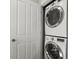 Stacked washer and dryer with white front and chrome trim, located behind a white door at 3708 Ashford Creek Ne Hl # 3708, Atlanta, GA 30319