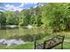 Scenic pond view with fountains and a relaxing bench for enjoying nature at 3708 Ashford Creek Ne Hl # 3708, Atlanta, GA 30319