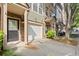 Exterior of well maintained townhome with stone facade and covered entry next to private garage at 3708 Ashford Creek Ne Hl # 3708, Atlanta, GA 30319