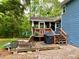 Outdoor deck area with furniture and a grill, ideal for relaxing and entertaining at 5364 Muirwood Pl, Powder Springs, GA 30127
