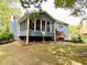 The home's back exterior features a screened-in porch and a deck for outdoor enjoyment at 5364 Muirwood Pl, Powder Springs, GA 30127