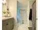 Bright bathroom featuring a gray vanity with modern fixtures and marble-look tile flooring at 5364 Muirwood Pl, Powder Springs, GA 30127