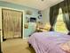 Cozy bedroom with closet featuring macrame curtains, a window, and a desk area at 5364 Muirwood Pl, Powder Springs, GA 30127