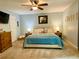 Spacious bedroom with large bed, side tables, and carpet flooring at 5364 Muirwood Pl, Powder Springs, GA 30127