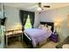Bright bedroom with a view and a comfortable desk featuring a window with natural light at 5364 Muirwood Pl, Powder Springs, GA 30127