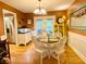 Cozy dining room featuring hardwood floors, a round table with white chairs, and French doors to screened porch at 5364 Muirwood Pl, Powder Springs, GA 30127