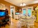 Charming dining area with hardwood floors, white wainscoting, a round table and French doors to the outdoor porch at 5364 Muirwood Pl, Powder Springs, GA 30127