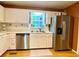 Well-lit kitchen with stainless steel appliances, bright cabinets, and natural light at 5364 Muirwood Pl, Powder Springs, GA 30127