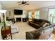 Spacious living room with vaulted ceilings, a brick fireplace, and expansive seating arrangements, ideal for gatherings at 5364 Muirwood Pl, Powder Springs, GA 30127
