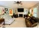 Bright living room boasts vaulted ceilings, a cozy brick fireplace, and plenty of space for comfortable seating at 5364 Muirwood Pl, Powder Springs, GA 30127