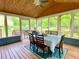 Relaxing sunroom with natural light, a ceiling fan, and views of the backyard at 5364 Muirwood Pl, Powder Springs, GA 30127