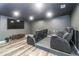 Basement theater room with tiered seating and a large screen tv at 626 Discovery Ct, Acworth, GA 30102