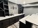 Stylish basement wet bar with a built in wine fridge, custom cabinets, and elegant countertop at 626 Discovery Ct, Acworth, GA 30102