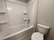 Bathroom with a tub and shower combo, toilet and shelves at 626 Discovery Ct, Acworth, GA 30102
