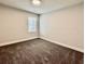 Cozy bedroom features neutral tones, one window, and plush carpeting at 626 Discovery Ct, Acworth, GA 30102