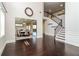 Spacious foyer with dark hardwood floors, staircase, and view into the formal dining room at 626 Discovery Ct, Acworth, GA 30102