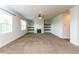 Spacious living room with carpeted floors, a fireplace, and built-in shelves at 626 Discovery Ct, Acworth, GA 30102