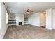 Bright living room featuring a fireplace, floating shelves, and a ceiling fan at 626 Discovery Ct, Acworth, GA 30102