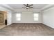 Main bedroom with a tray ceiling, two windows, and ensuite bathroom at 626 Discovery Ct, Acworth, GA 30102