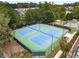 Aerial view of community tennis courts, surrounded by lush greenery and trees at 626 Discovery Ct, Acworth, GA 30102