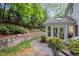 A charming outdoor patio area with landscaped garden and stone pathway at 7750 Landowne Dr, Atlanta, GA 30350