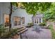 Inviting backyard featuring a stone patio with seating, lush greenery, and natural beauty at 7750 Landowne Dr, Atlanta, GA 30350